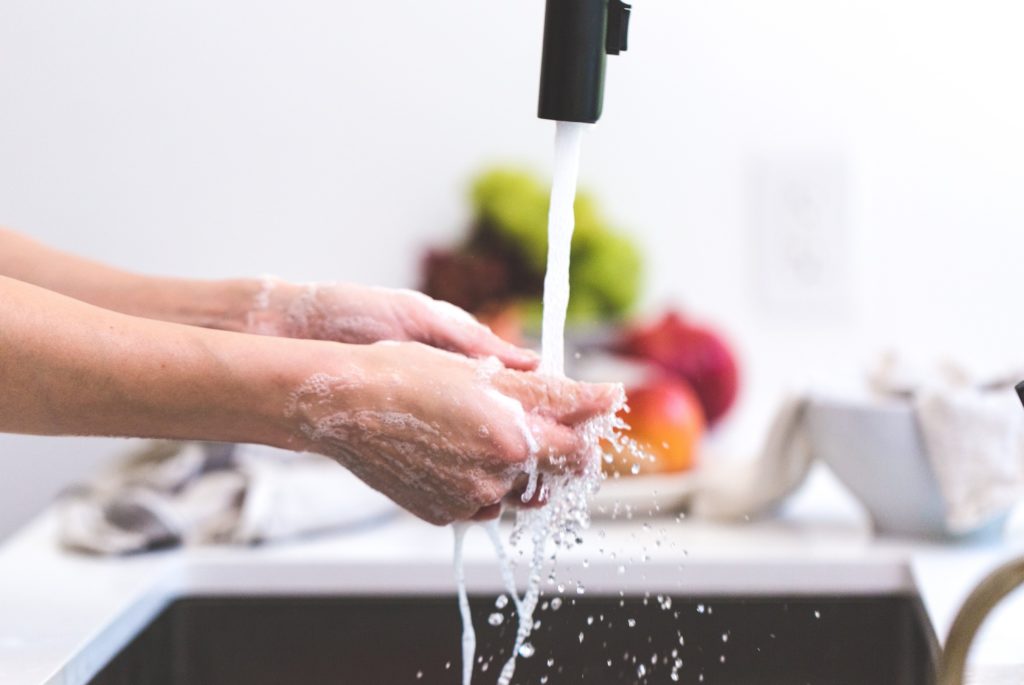 Person washing their hands - An important Covid-19 insurance payment update - insurance companies are making alternative payment arrangements for struggling customers during Covid-19.