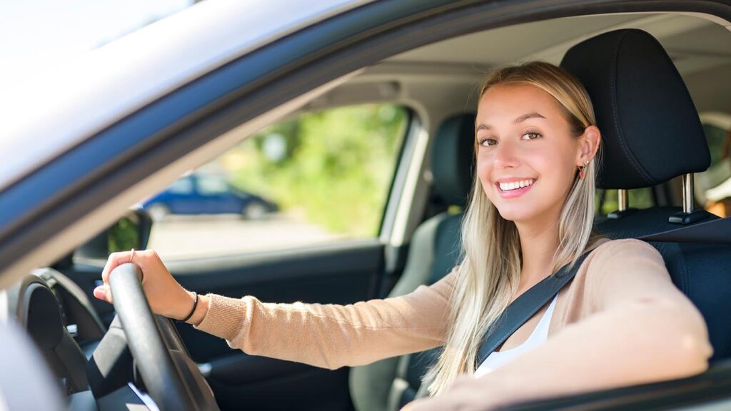 teen auto insurance coverage is needed for young drivers like this woman in her car